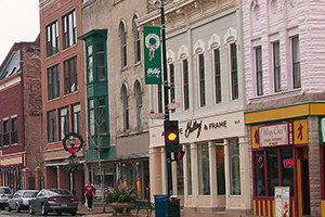 A downtown streetscape in Racine. A stoplight is on yellow.