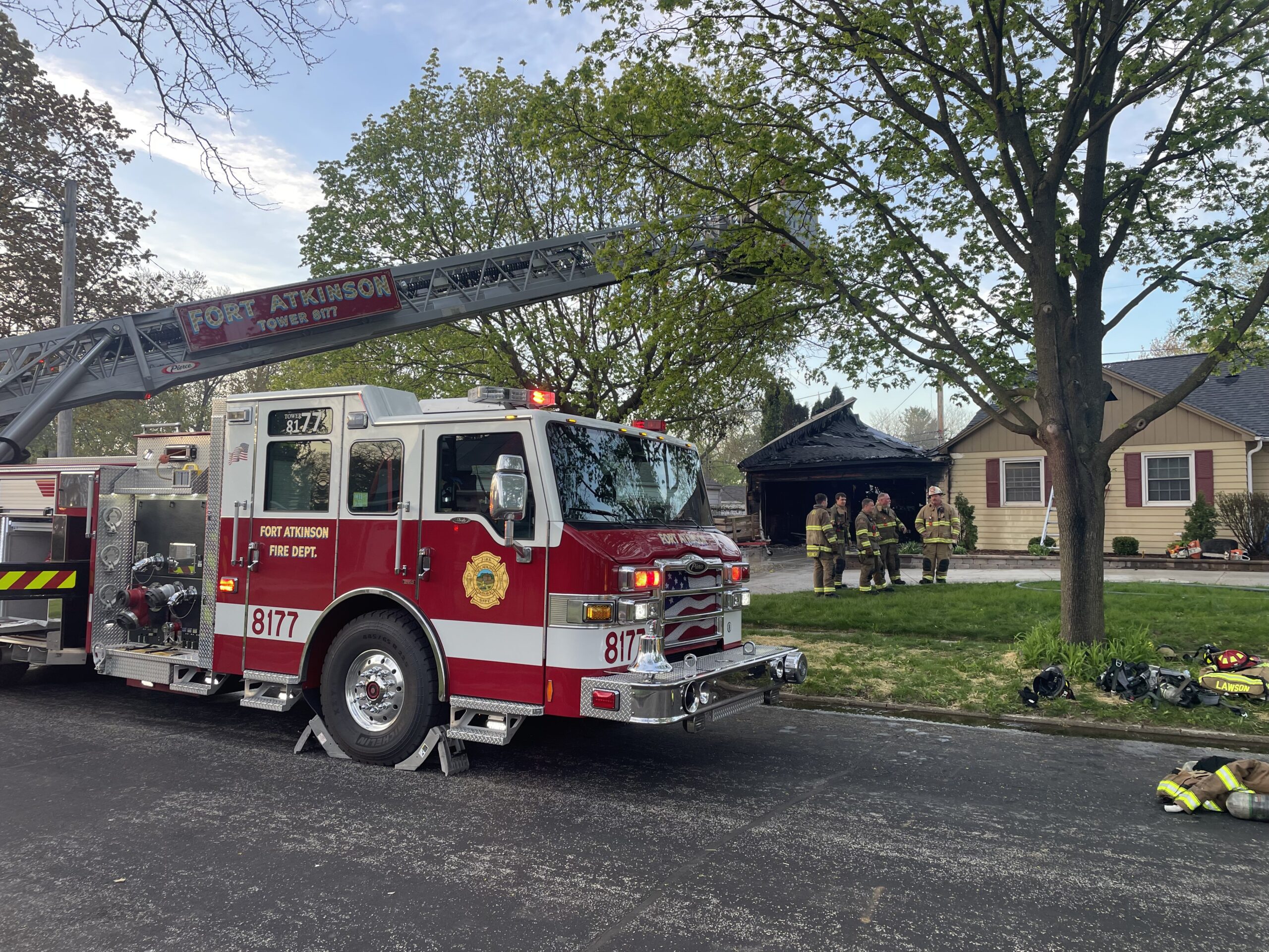 A photo of a fire truck outside of a residential home
